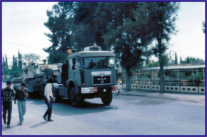 Truck hauling an Israeli tank through the streets of Jerusalem